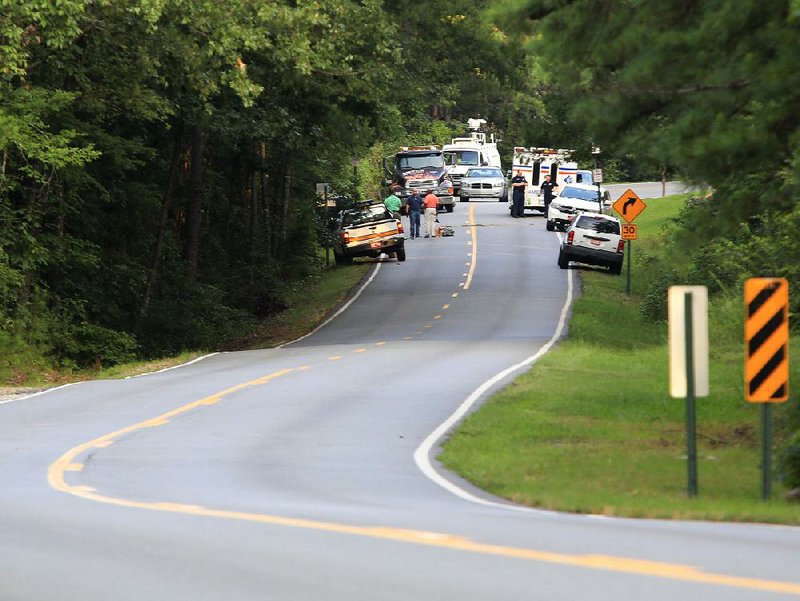  Arkansas Democrat-Gazette/STATON BREIDENTHAL --8/20/13-- Investigators work the scene of a shooting Tuesday evening near the parking lot for the East Summit Trail at Pinnacle Mountain State Park after a a State Park Ranger shot at a suspect. 