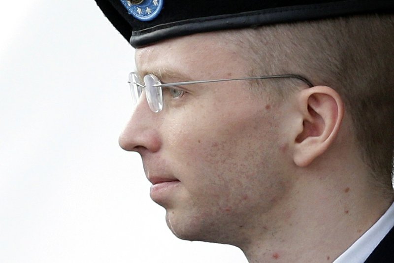 In this Tuesday, Aug. 20, 2013, file photo, Army Pfc. Bradley Manning is escorted to a security vehicle outside a courthouse in Fort Meade, Md., after a hearing in his court-martial. 