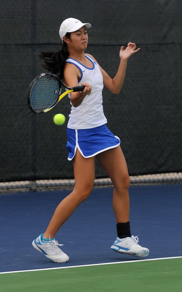 Tiffany Tang of Rogers hits a volley back Thursday, Aug. 22, 2013, during the game against Southside High School at Rogers High School.