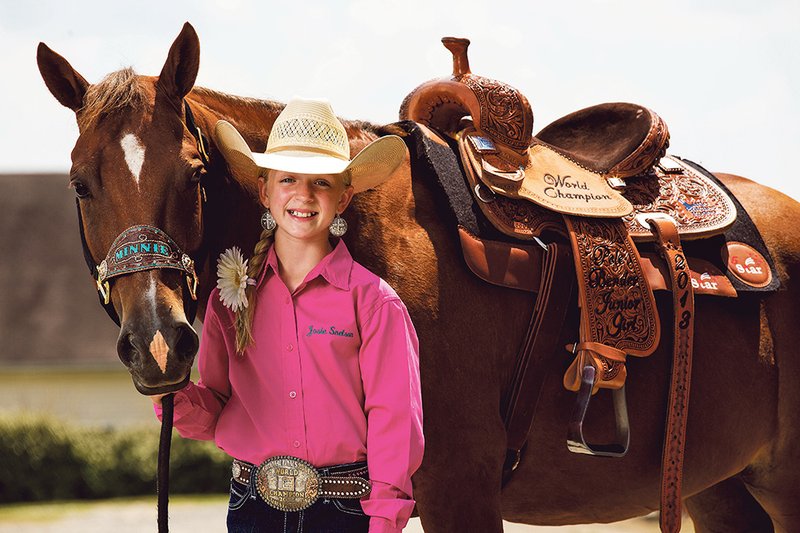 Josie Snelson, 11, and her horse Minnie recently received the title of world champion in pole bending in the National Little Britches Rodeo Finals in Colorado. 