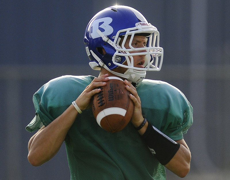 Bryant quarterback Brandan Warner looks to pass.