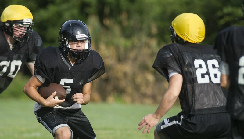 Miners running back Estevan Padillo (5) looks for yardage during fall practice at Bauxite High School.