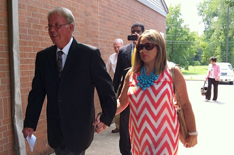 Saline County Sheriff Bruce Pennington (left) enters Saline County District Court in Benton on Monday, Aug. 26, 2013. Pennington pleaded guilty to public intoxication and resisting arrest after an incident at Denton's Trotline in Benton on June 29. 