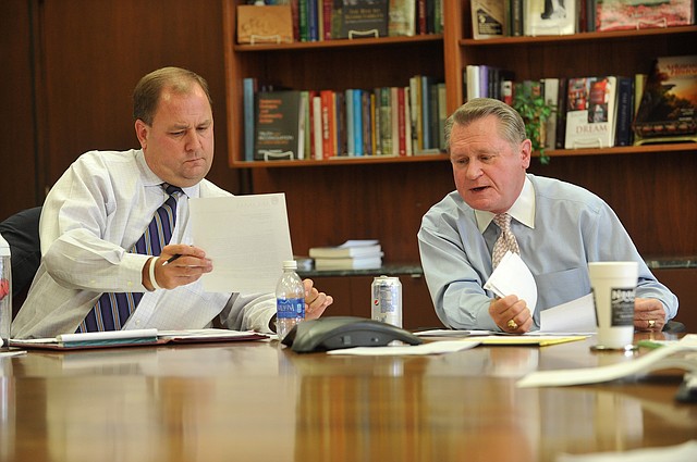 Chris Wyrick (left), vice chancellor for university advancement, and G. David Gearhart, chancellor of the University of Arkansas, talk to reporters Monday at the University of Arkansas to answer questions regarding the recent firing of John Diamond, associate vice chancellor for university relations.