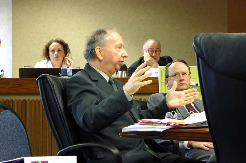 Mick Harrison, an attorney for Save the Ozarks, speaks Tuesday at a hearing before the Arkansas Public Service Commission in Little Rock while Southwestern Electric Power Co. attorney David Matthews (center) and Stephen Williams, general counsel for the Arkansas Electric Cooperative Corp, listen in. Save the Ozarks opposes a 48-mile high-voltage power line SWEPCO wants to build in Benton and Carroll counties. 