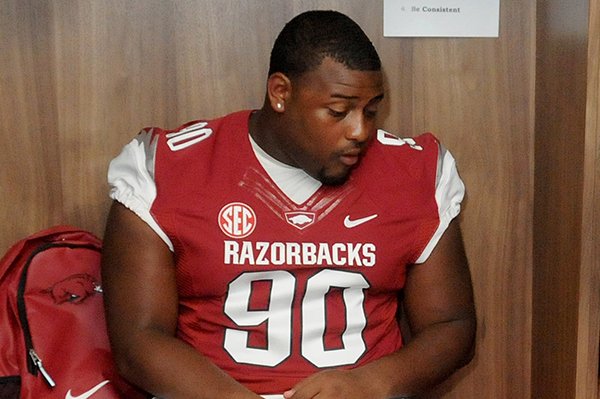 University of Arkansas freshman Ke'Tyrus Marks plays a game of cards as he waits at his locker during media day at the University of Arkansas in Fayetteville.