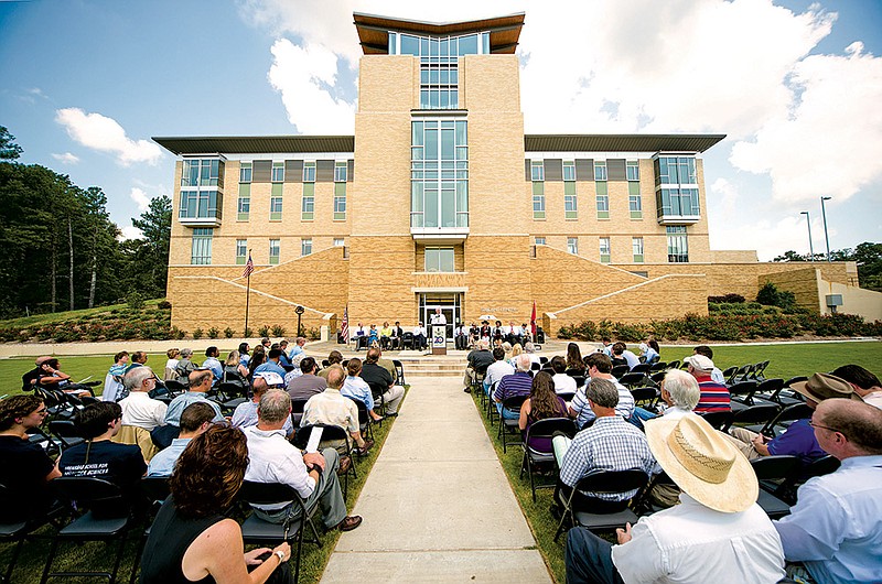 People gathered in front of the new residence hall at the Arkansas School for Mathematics, Sciences and the Arts in Hot Springs during a ceremony marking the 20th anniversary of the school.