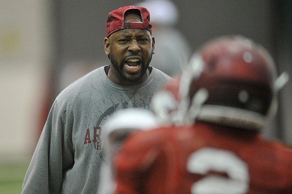 University of Arkansas assistant coach Taver Johnson works with his team during practice in Fayetteville.