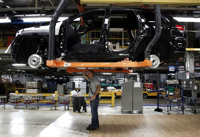 A chassis assembly line supervisor checks a vehicle at a Chrysler plant in Detroit in May. Revised figures released Thursday showed stronger-than-estimated growth in the second quarter, propelled by gains in durable goods such as automobiles and appliances. 