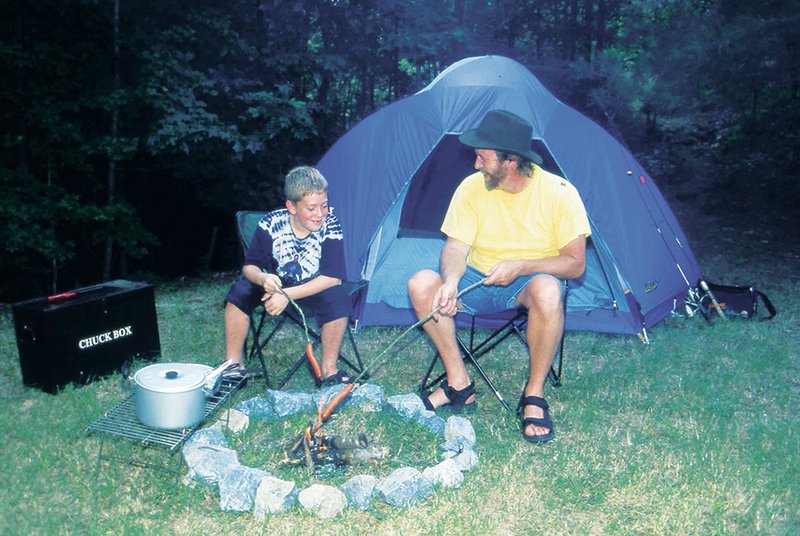 Cooking hot dogs on a stick is a fun method of camp cooking.