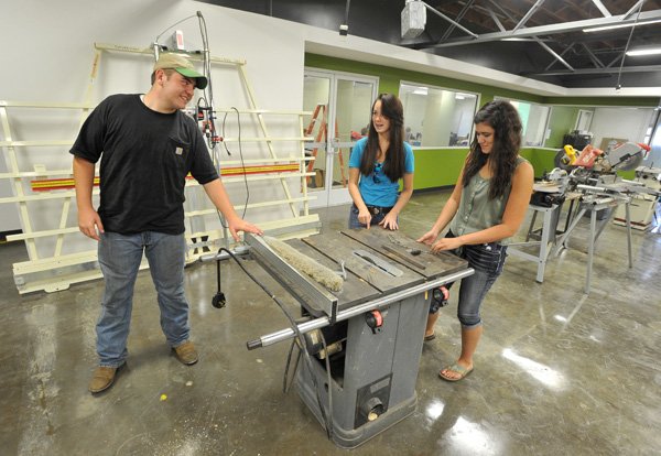 Greenland students (left to right) McKenzie Fanning, junior, Ashley Warren, Senior, and Allie Overdorf, senior, take a look at some of the equipment in the wood shop area in the newly renovated building at Greenland High School Thursday morning. The new vo-ag program will give students more options for their electives at Greenland High School.