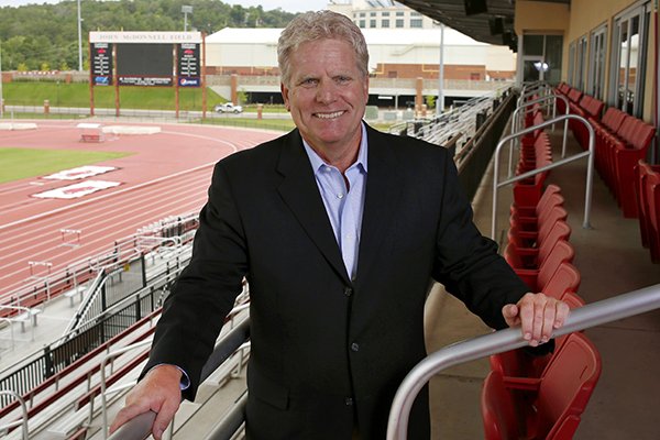 University of Arkansas men's cross country and track and field Head coach Chris Bucknam stands outside his office at the outdoor track facility in Fayetteville where he will begins his sixth season with the Arkansas Razorbacks.