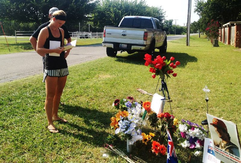 Sarah Harper, Christopher Lane’s girlfriend, stands at a memorial set up at the site in Duncan, Okla., where police say Lane was shot and killed on Aug. 16 by three “bored” teenagers. 