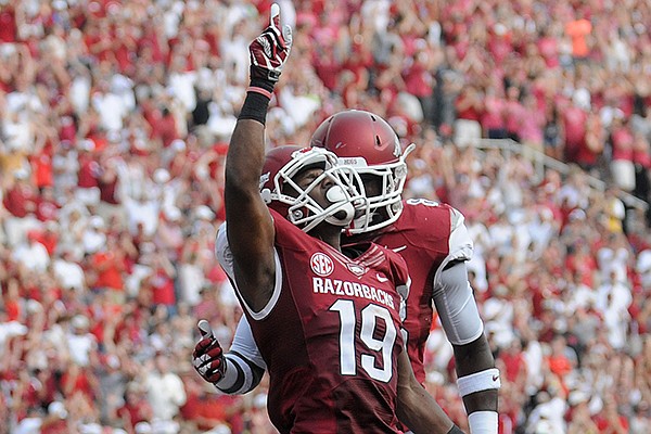 Arkansas receiver Javontee Herndon celebrates after catching a 49-yard touchdown pass from Brandon Allen in the second quarter of the Razorbacks' 34-14 win over Louisiana-Lafayette on Saturday, Aug. 31, 2013 at Razorback Stadium in Fayetteville. 