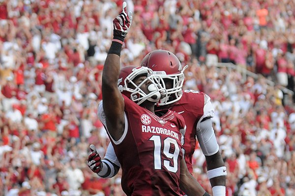 Arkansas receiver Javontee Herndon celebrates after catching a 49-yard touchdown pass from Brandon Allen in the second quarter of the Razorbacks' 34-14 win over Louisiana-Lafayette on Saturday, Aug. 31, 2013 at Razorback Stadium in Fayetteville. 