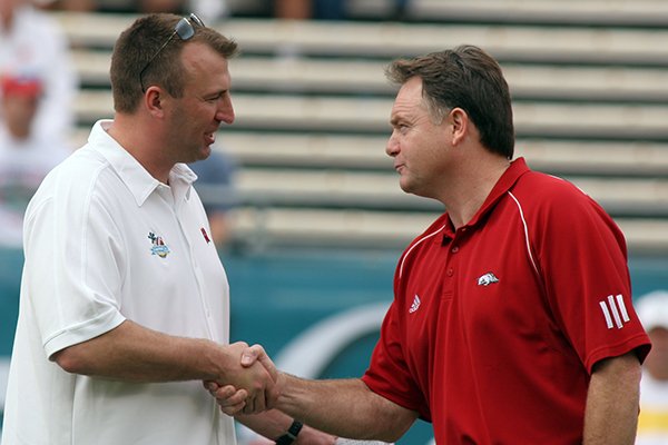 Arkansas coach Houston Nutt and Wisconsin coach Bret Bielema shake hands prior to the Capital One Bowl in Orlando on Jan. 1, 2007. 