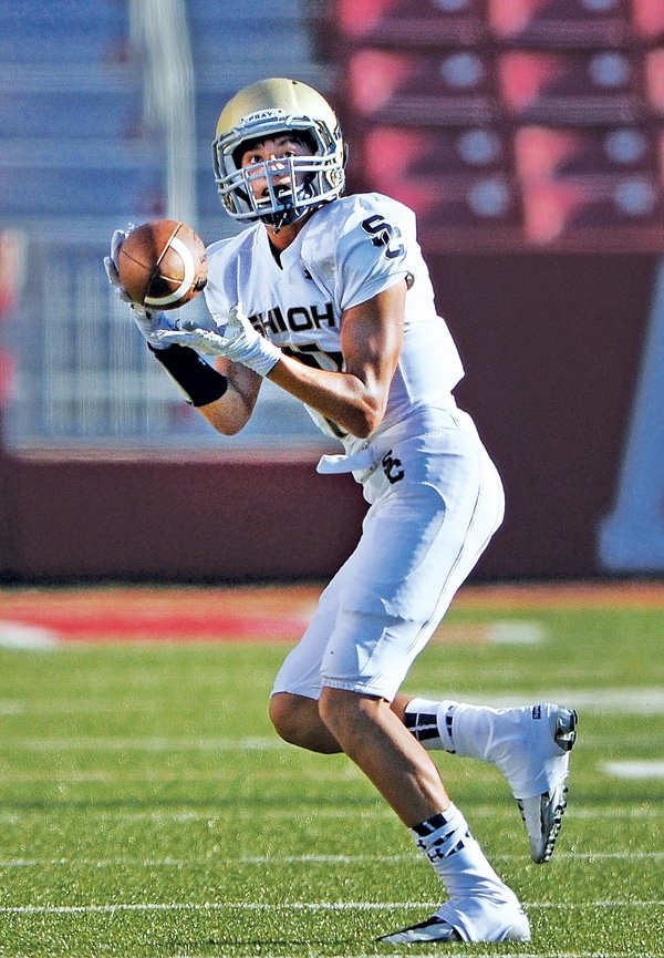 Adler Goode, Shiloh Christian wide receiver, catches a pass before running for a touchdown Monday in the first half against Siloam Springs.