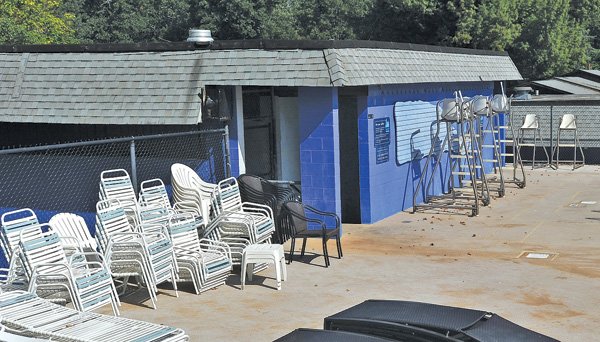 Chairs are stacked next to the pool house at the Wilson Park pool Thursday afternoon as crews prepare to renovate the pool house and concession building in late September. The buildings haven’t had any major work done for 30 years.
