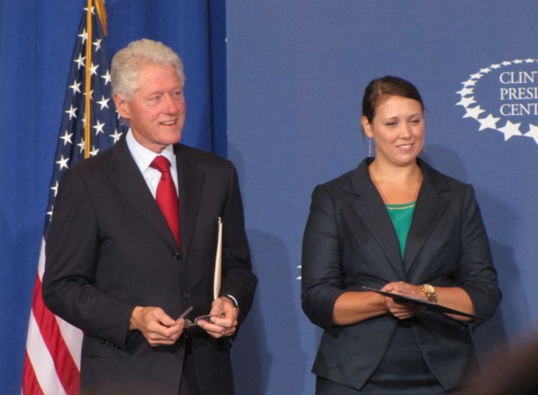 Bill Clinton stands on stage with Clinton School student body president Mara D'Amico Wednesday in Little Rock.