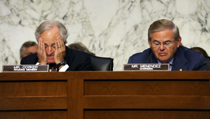 Sen. Bob Corker (left) of Tennessee, the ranking Republican on the Senate Foreign Relations Committee, listens to testimony Wednesday on Syria. He is shown with Senate Foreign Relations Committee Chairman Sen. Robert Menendez, D-N.J.