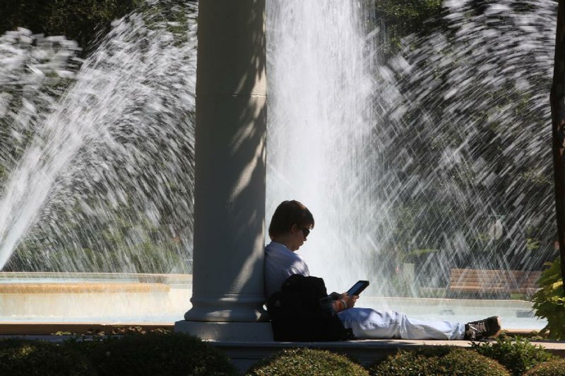 Arkansas Democrat-Gazette/RICK MCFARLAND --09/05/13--   Nicholas Vest, of Conway, reads on his electronic book by the Harding Centennial Plaza fountain on the University of Central Arkansas campus in Conway Sept. 5, 2013. 