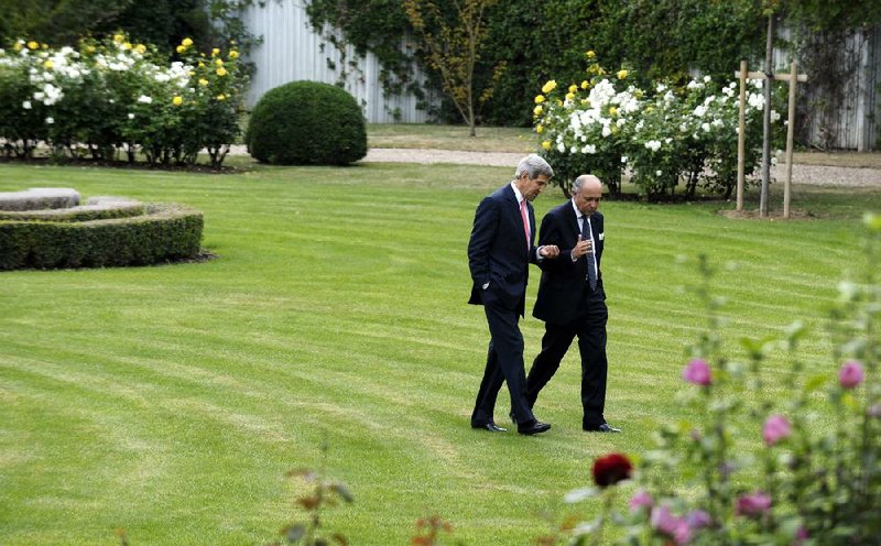 Secretary of State John Kerry (left) talks with French Foreign Minister Laurent Fabius in Paris on Saturday about gaining international backing for a strike against Syria. 