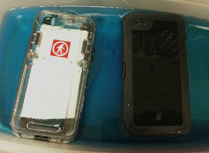 Special to the Arkansas Democrat Gazette - 09-06-2013 -  The Outdoor Tech Safe 5 Waterproof case and the Ballistic Hydra case for iPhone 5 soak during one of the tests to prove the cases are waterproof as claimed.
