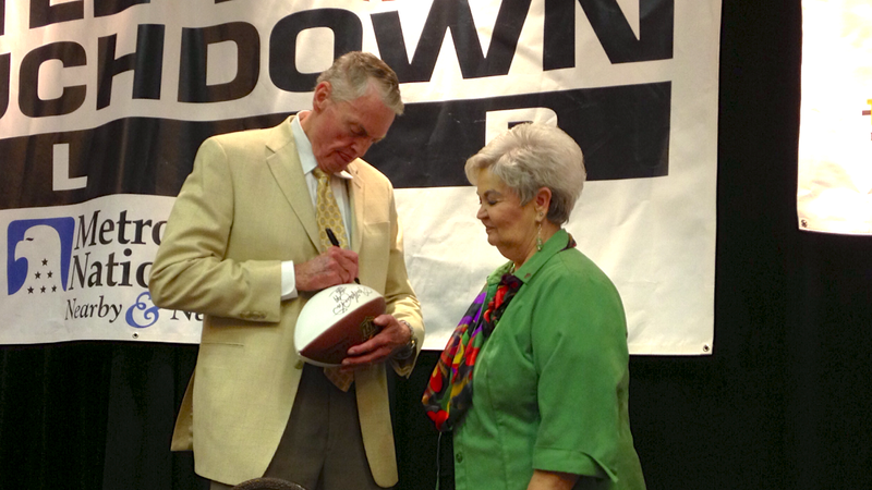 Former Nebraska coach Tom Osborne signed autographs for fans at the Little Rock Touchdown Club on Monday afternoon. 