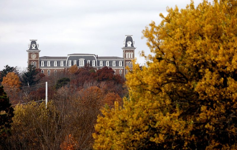 FILE- Old Main is seen over the treetops on the University of Arkansas campus in Fayetteville.