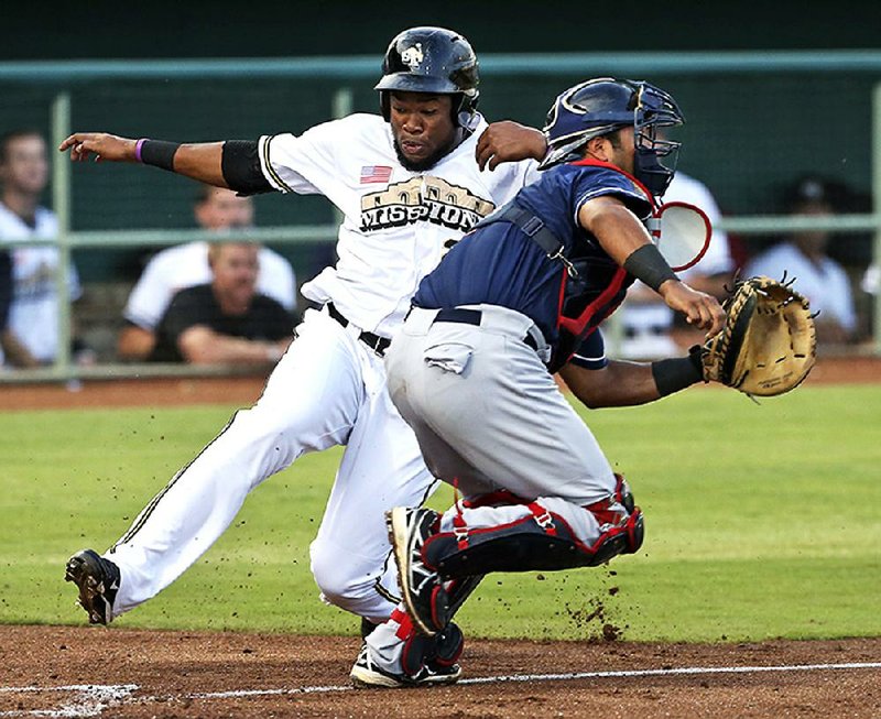 San Antonio’s Yelson Asencio slips around Arkansas catcher Carlos Ramirez to score the Missions’ only run in a 1-0 victory in the Texas League Championship Series on Tuesday in San Antonio. 