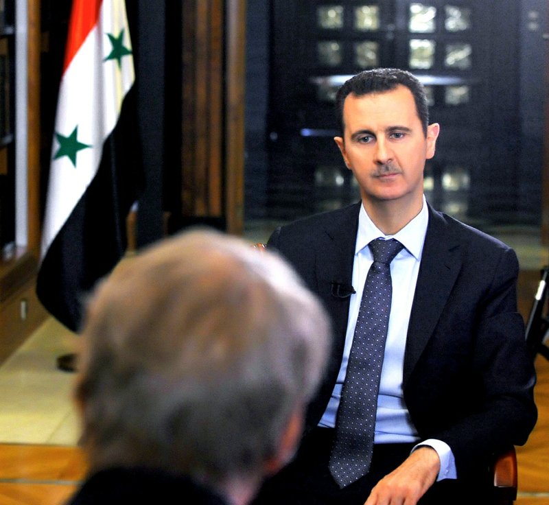In this Sunday, Sept. 8, 2013, photo released by the Syrian official news agency SANA, PBS host Charlie Rose, foreground, interviews Syrian President Bashar Assad at the presidential palace in Damascus, Syria. 