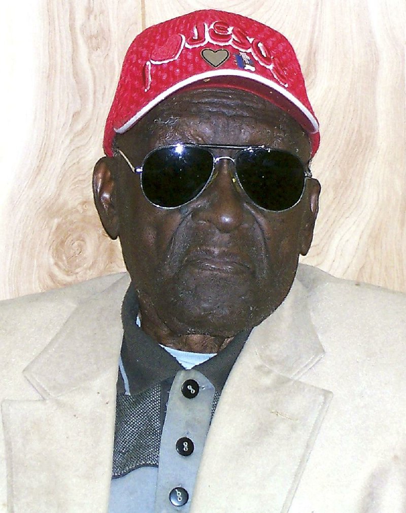 In this 2011 photo provided by the Pine Bluff Commercial, Monroe Isadore poses for photos on his 105th birthday in Pine Bluff, Ark. Authorities in Arkansas halted a standoff on Saturday, Sept. 7, 2013, when they shot and killed Isadore, 107, who opened fire at them. (AP Photo/Courtesy Pine Bluff Commercial)