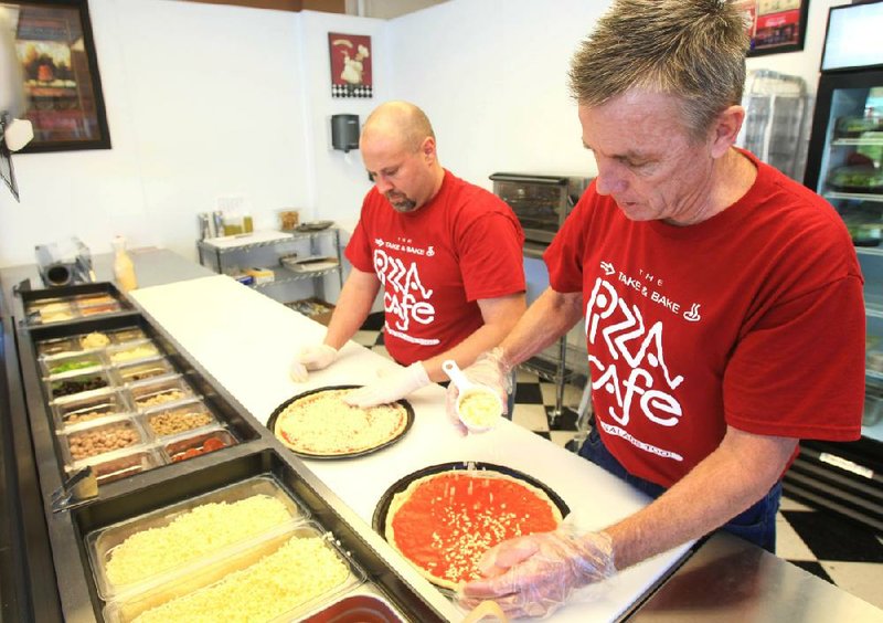 The Take & Bake Pizza Cafe in west Little Rock was short-lived, but Pizza Cafe owner Richard Harrison is installing the concept in his two Little Rock full-service restaurants later this month, with help from Take & Bake owner Hank van Rossum (right). 