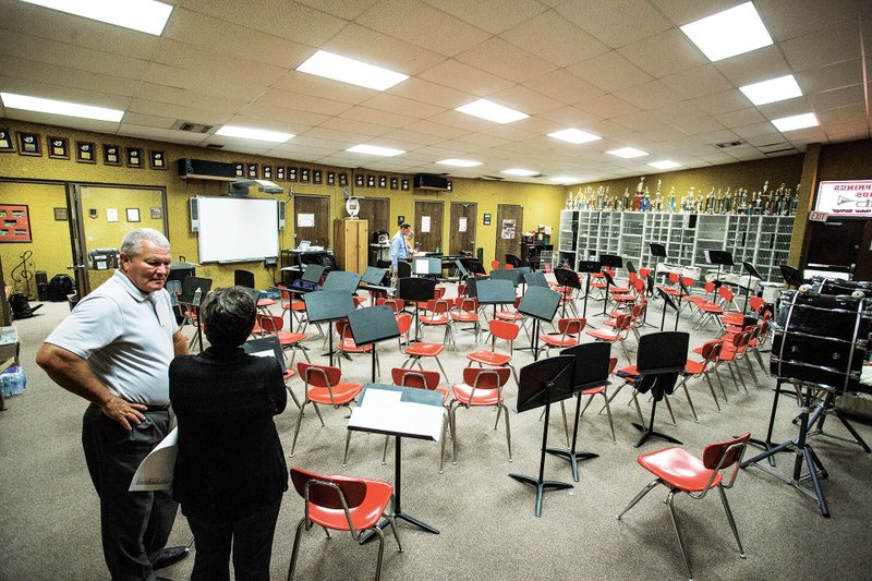 Heber Springs School District Superintendent Russell Hester, left, talks with band director Traci Jernigan about future plans for school facilities, including the often overcrowded band room.