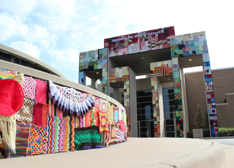 Knitted yarn-work covers the front of the Arkansas Arts Center and its fountain Friday in what organizers say was the second-largest yarn-bombing ever.