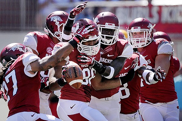 Arkansas teammates congratulate defensive end Trey Flowers after he intercepted a pass in the first quarter of the game against Southern Miss on Saturday September 14, 2013 at Razorbacks Stadium in Fayetteville. 