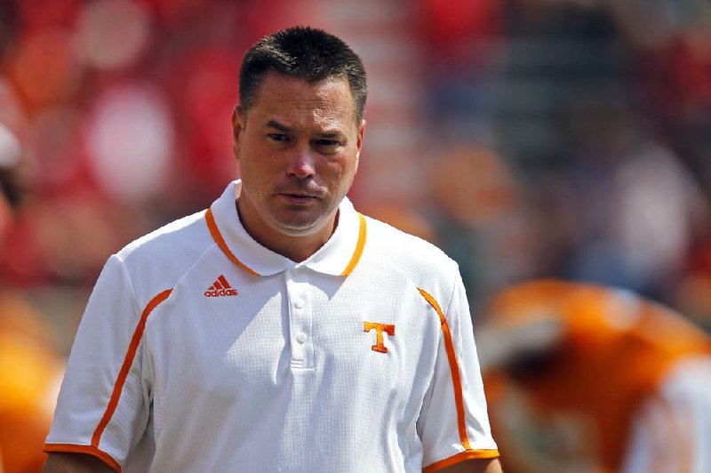 Tennessee head coach Butch Jones watches his team warm up before an NCAA college football game against Western Kentucky on Saturday, Sept. 7, 2013 in Knoxville, Tenn. (AP Photo/Wade Payne)