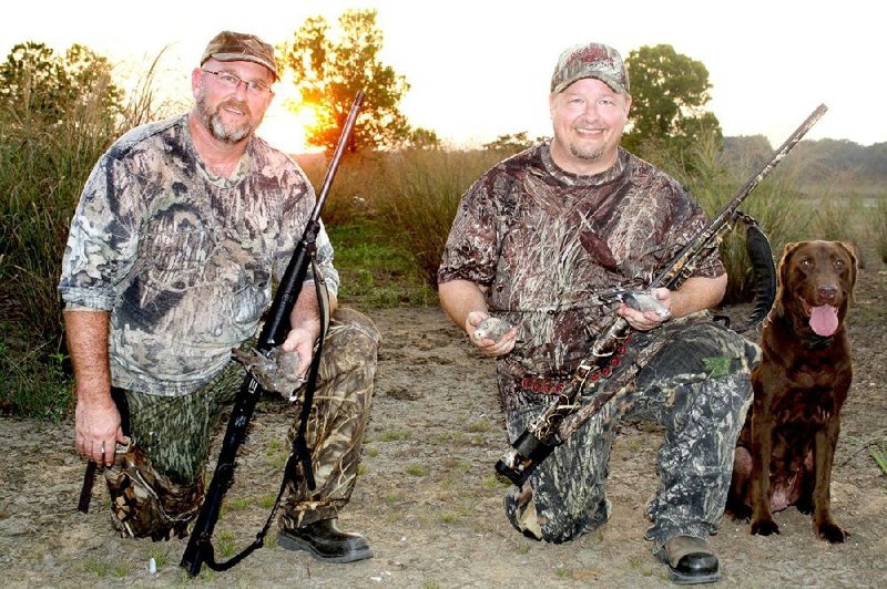Arkansas Democrat-Gazette/BRYAN HENDRICKS
Pete Hornibrook of Little rock, left, and Alan Thomas of Russellville enjoy the last minutes of a successful dove hunt Saturday on the banks of the Arkansas River.
