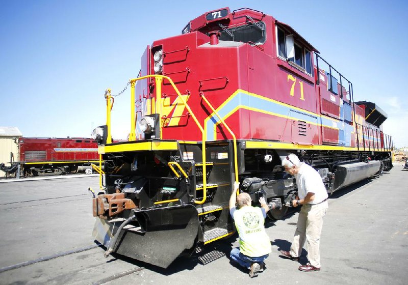 Casey Shepherd, chief mechanical officer at Arkansas & Missouri Railroad, shows Chairman Reilly McCarren the leaf blowers under the front end of a new locomotive. The railroad bought three new locomotives, the first in 27 years. 