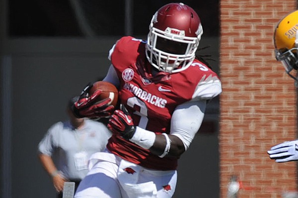 Arkansas running back Alex Collins (3) carries the ball Saturday, Sept. 14, 2013, during the first quarter of play at Razorback Stadium in Fayetteville.