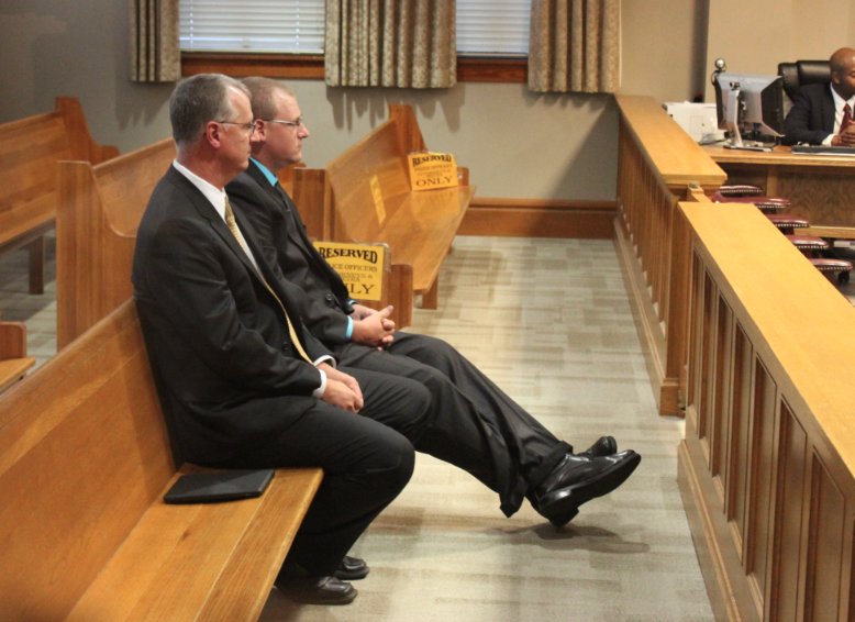 Josh Hastings sits with his father, Little Rock Police Department Capt. Terry Hastings, before jury selection is set to begin Monday morning. 