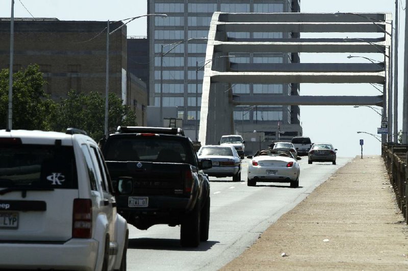 Traffic crosses the Broadway Bridge in North Little Rock, Ark. on Friday, Sept. 13, 2013. The bridge over the Arkansas River between North Little Rock and Little Rock carries 24,000 cars and trucks daily and is scheduled for replacement. (AP Photo/Danny Johnston)