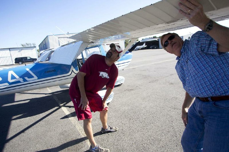 
Arkansas Democrat-Gazette/MELISSA SUE GERRITS 09/15/13 - Marshall Kelley of Greenbrier, left, does a preflight check with instructor Steve Stansel, right, September 14, 2013 at the Conway Municipal Airport. Conway Airport is home to the Sparrow Flying Club which holds flight classes and allows for members to pool resources and have access to a variety of aircraft for carrying needs. 