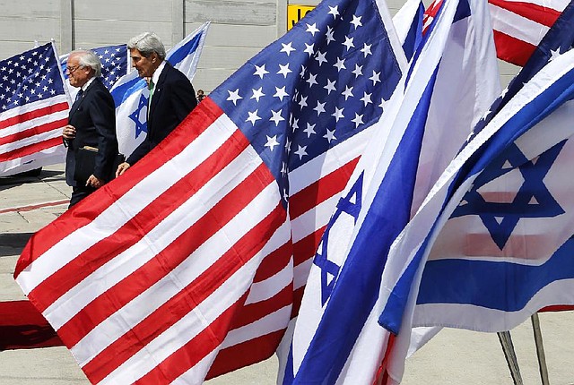 U.S. Secretary of State John Kerry, right, walks with U.S. Special Envoy for Israeli and Palestinian Negotiations Martin Indyk after arriving at Ben Gurion airport in Tel Aviv, Israel, Sunday, Sept. 15, 2013. Kerry arrived in Israel for a meeting with Israeli Prime Minister Benjamin Netanyahu, a day after sealing a deal with Russia on securing Syria's chemical weapons stockpiles. Kerry made a stop in Jerusalem to brief Netanyahu on the agreement as well as discuss developments in the Israeli-Palestinian peace process. (AP Photo/Larry Downing, Pool)