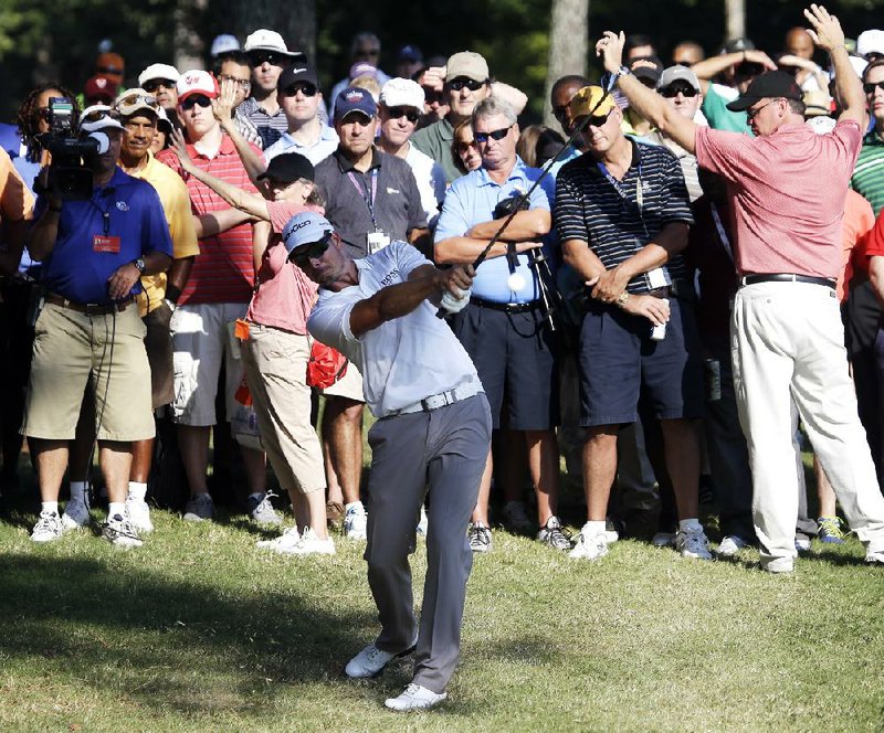 Henrik Stenson hits from the rough on the 16th fairway during the first round of play in the PGA Tour Championship golf tournament at East Lake Golf Club in Atlanta, Thursday, Sept. 19, 2013. (AP Photo/John Bazemore)