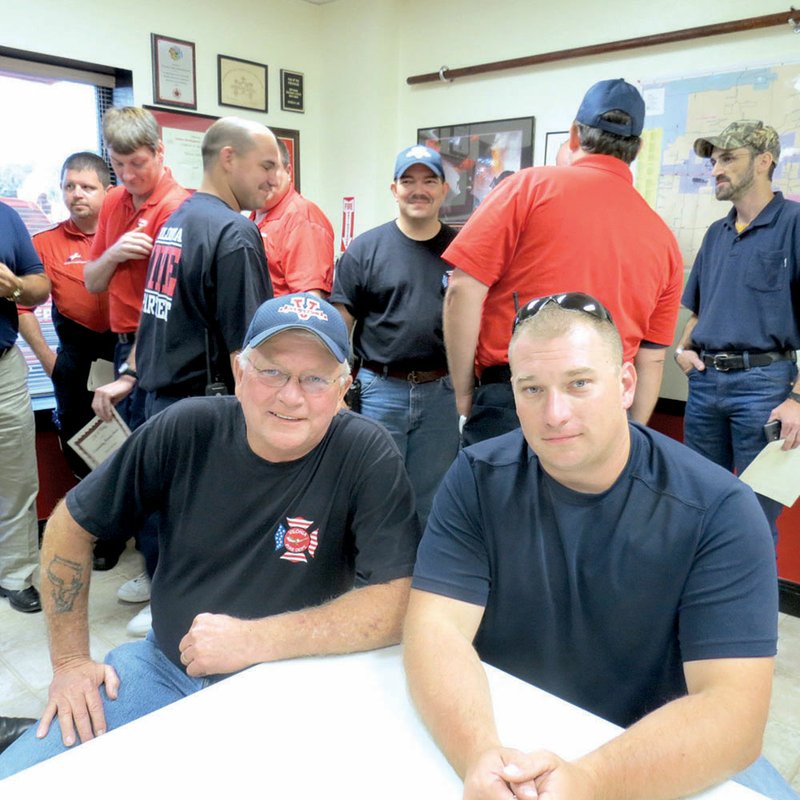 Jack Hancock Jr., a part-time firefighter in Vilonia and a full-time firefighter in Little Rock, right, put his EMT training to use when he performed CPR on his father, Jack Hancock Sr., left, and saved his life.
