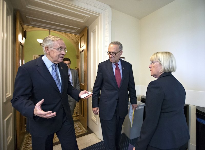 From left, Senate Majority Leader Harry Reid, D-Nev., Sen. Chuck Schumer, D-N.Y., the Democratic Policy Committee chairman, and Budget Committee Chair Patty Murray, D-Wash., speak privately before attending a news conference on Capitol Hill in Washington, Thursday, Sept. 19, 2013. The Democratic leaders repeated their resolve to not touch the Affordable Care Act if House Republicans make rescinding "Obamacare" a part of a continuing resolution to fund the government.