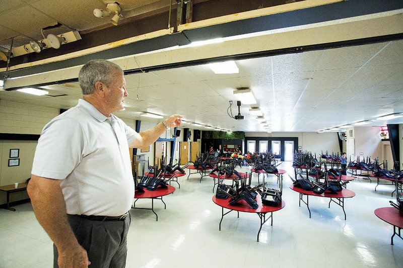 Heber Springs School District Superintendent Russell Hester points to the end of the cafeteria at Heber Springs High School, where he hopes an expansion is planned.