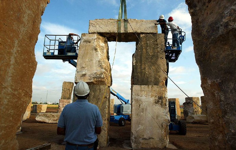 Workers put the finishing touches on the Stonehenge replica constructed for this week’s giant DruidFest in Eureka Springs. 