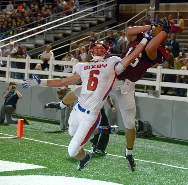 Springdale senior Terry Mounce hauls in a touchdown catch as Bixby, Okla. junior Blake Cooper defends in the first quarter Friday, Sept. 20, 2013 at Jarrell Williams Bulldog Stadium in Springdale.